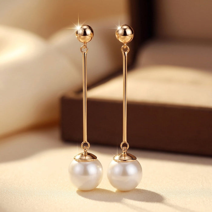 Pendientes largos de perlas doradas
